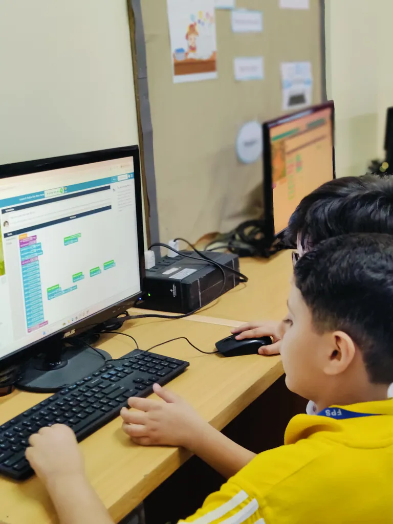 Students building logic with block-based coding
